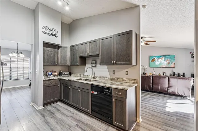 a kitchen with a sink stove and wooden cabinets