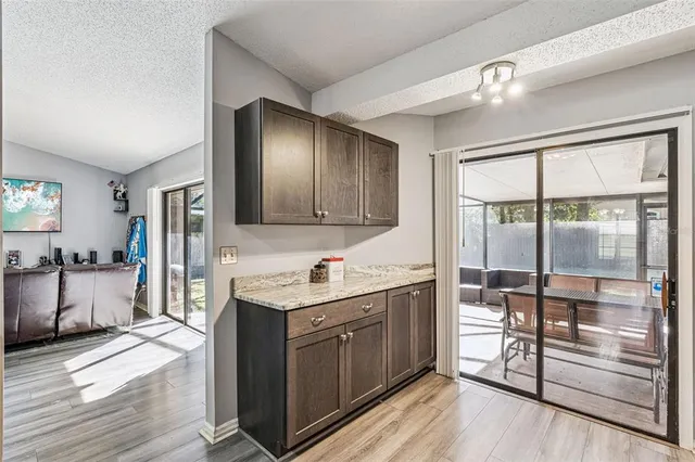 a view of an empty room with wooden floor and window