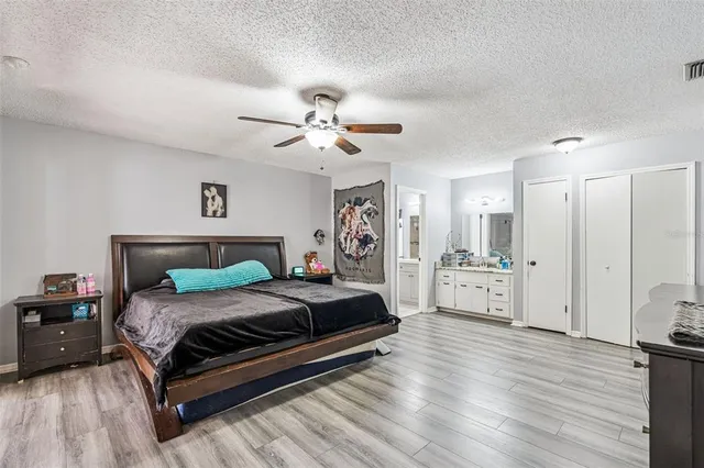 a bedroom with a bed and a wooden floor