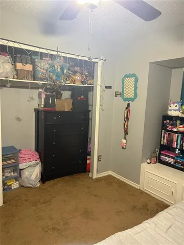 a view of a patio with table and chairs with plants and wooden fence