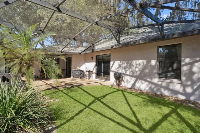 a view of a backyard with table and chairs under an umbrella