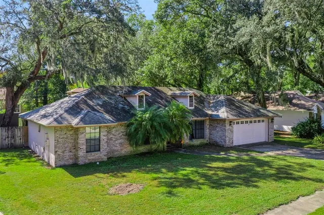 a view of a house with a backyard and a tub