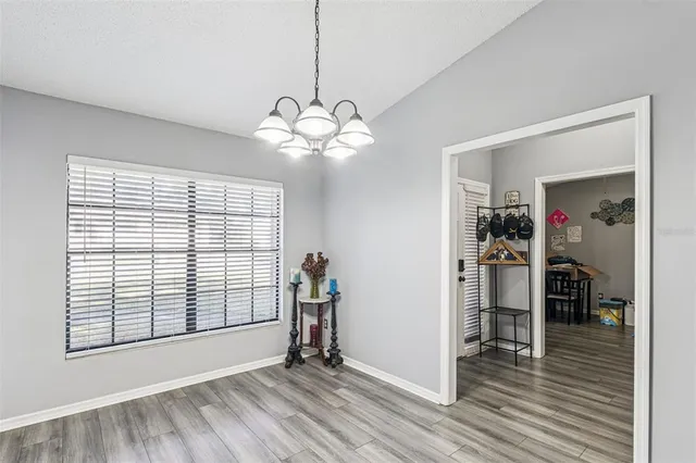 a kitchen with stainless steel appliances granite countertop a stove top oven a sink dishwasher and a refrigerator with wooden floor