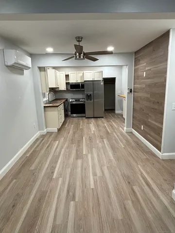 a view of kitchen with refrigerator sink and stove