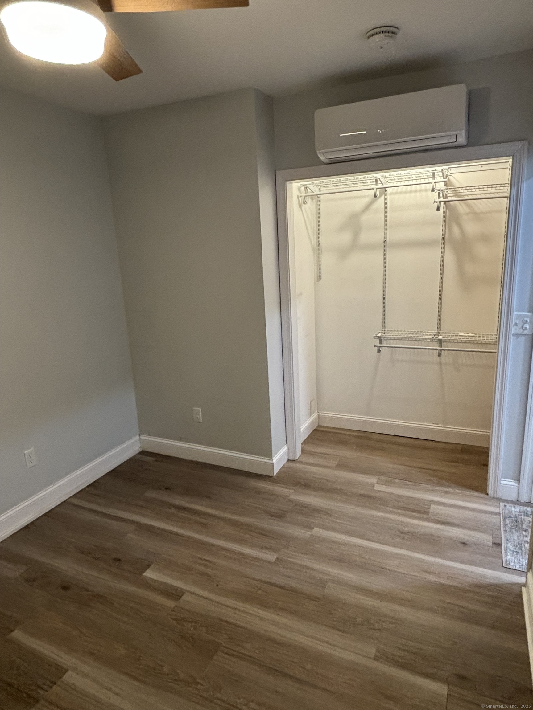 171 Moreland Avenue, Unit 1 Waterbury, CT 06705 - Photo 5 of 10 a view of a room with wooden floor and white walls