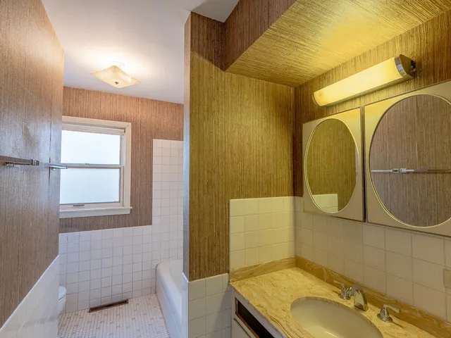 a bathroom with a sink a mirror and a shower