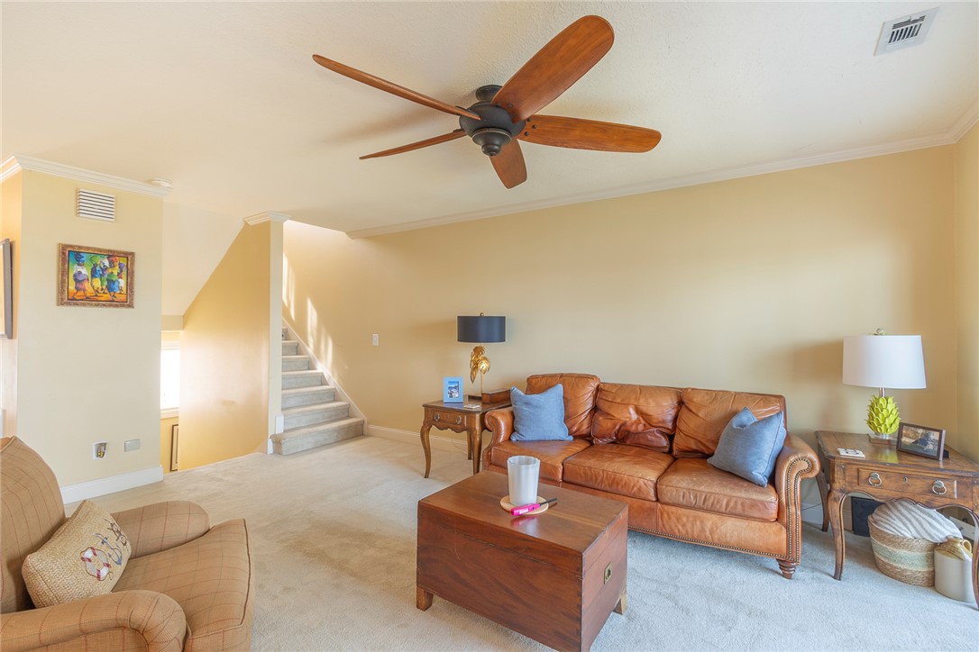 7 Harbor Gate, Unit 7 BUILDING 2 Anderson, SC 29625 - Photo 12 of 47 This living room features a ceiling fan, crown molding, and carpeted flooring for comfort.