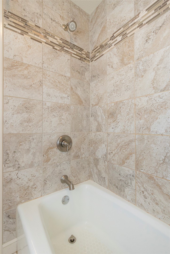 7 Harbor Gate, Unit 7 BUILDING 2 Anderson, SC 29625 - Photo 21 of 47 This bathroom features elegant tiled walls, offering a clean and inviting atmosphere.