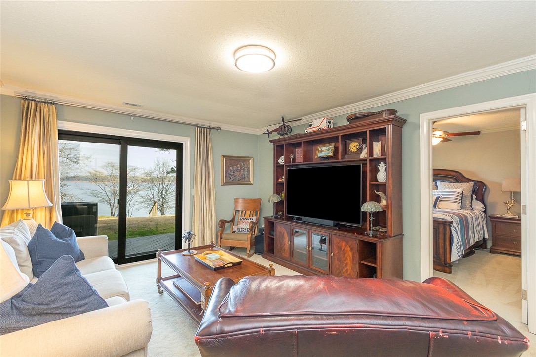 7 Harbor Gate, Unit 7 BUILDING 2 Anderson, SC 29625 - Photo 30 of 47 This inviting living room with crown molding opens to a serene waterfront view through sliding doors.