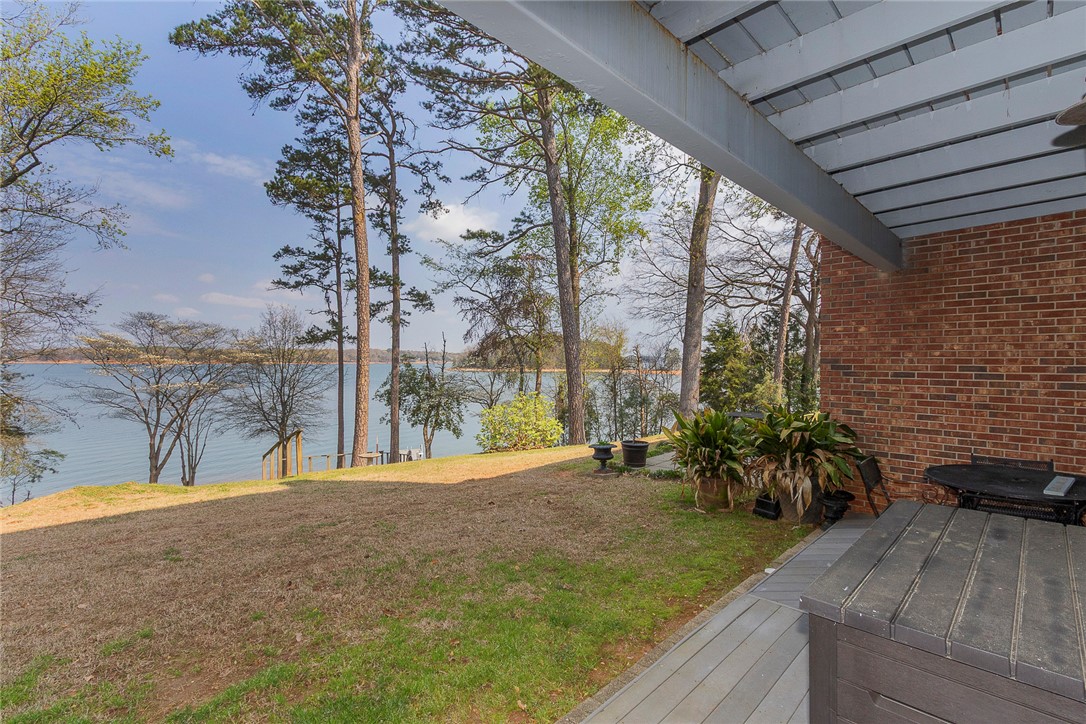 7 Harbor Gate, Unit 7 BUILDING 2 Anderson, SC 29625 - Photo 3 of 47 This serene lakeside property offers tranquil views and a spacious outdoor retreat.