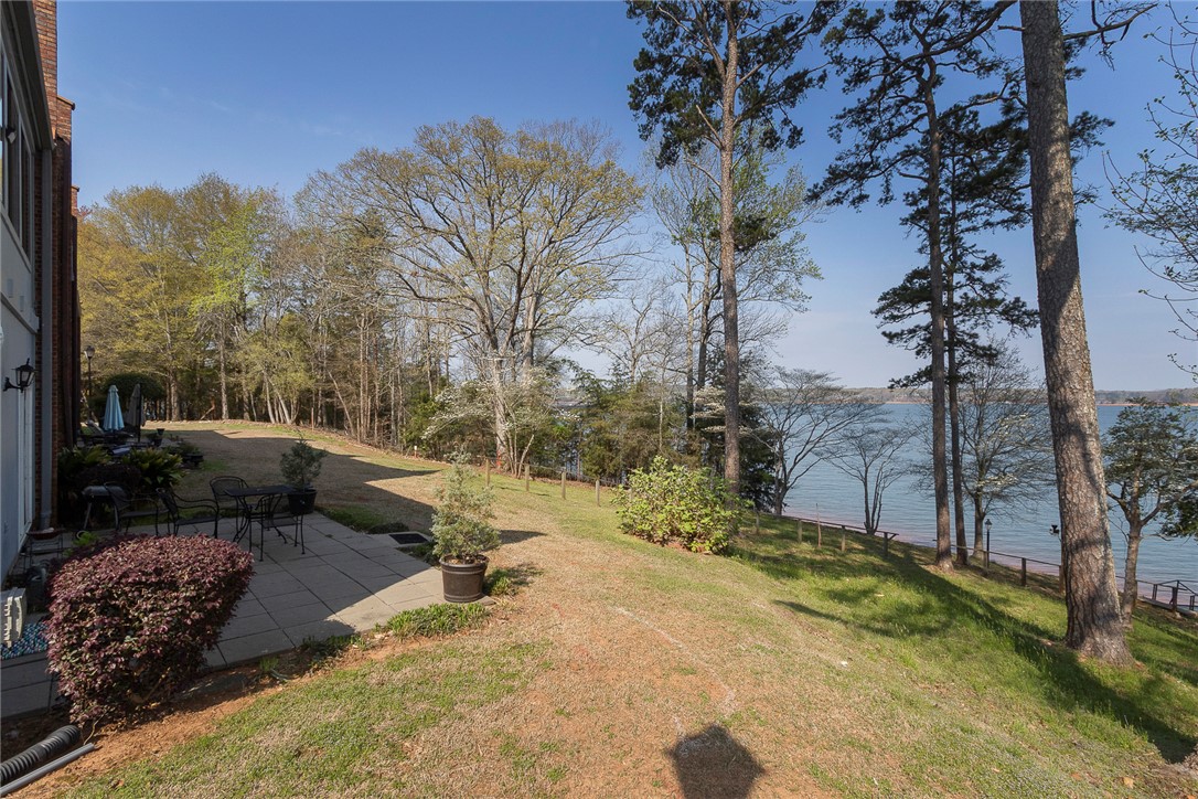 7 Harbor Gate, Unit 7 BUILDING 2 Anderson, SC 29625 - Photo 39 of 47 This serene outdoor space offers a private patio and captivating water views, perfect for relaxation.