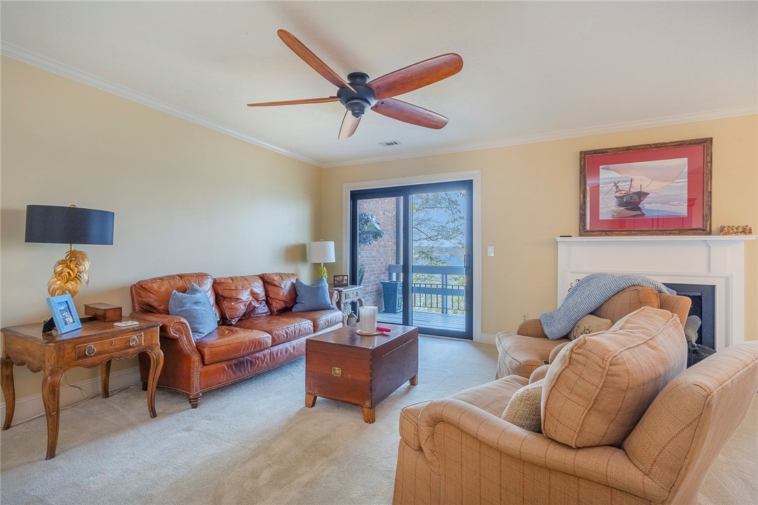 7 Harbor Gate, Unit 7 BUILDING 2 Anderson, SC 29625 - Photo 9 of 47 This inviting living area boasts a cozy fireplace and convenient sliding door access to outdoor space.