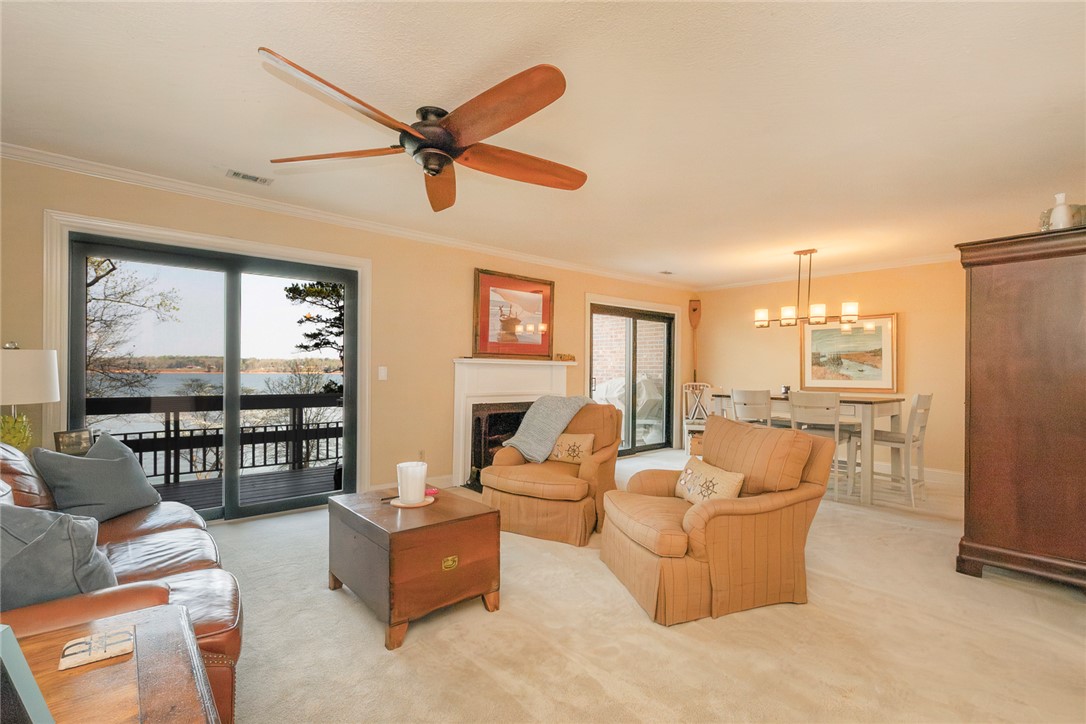 7 Harbor Gate, Unit 7 BUILDING 2 Anderson, SC 29625 - Photo 10 of 47 This inviting space features a cozy fireplace, abundant natural light, and serene water views.