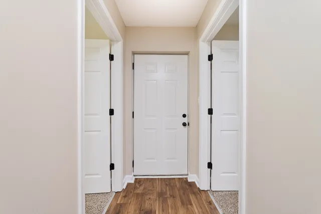 a view of room with wooden floor
