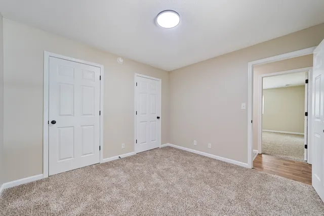 a view of an empty room and closet area