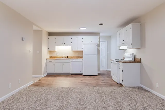 a kitchen with refrigerator and cabinets