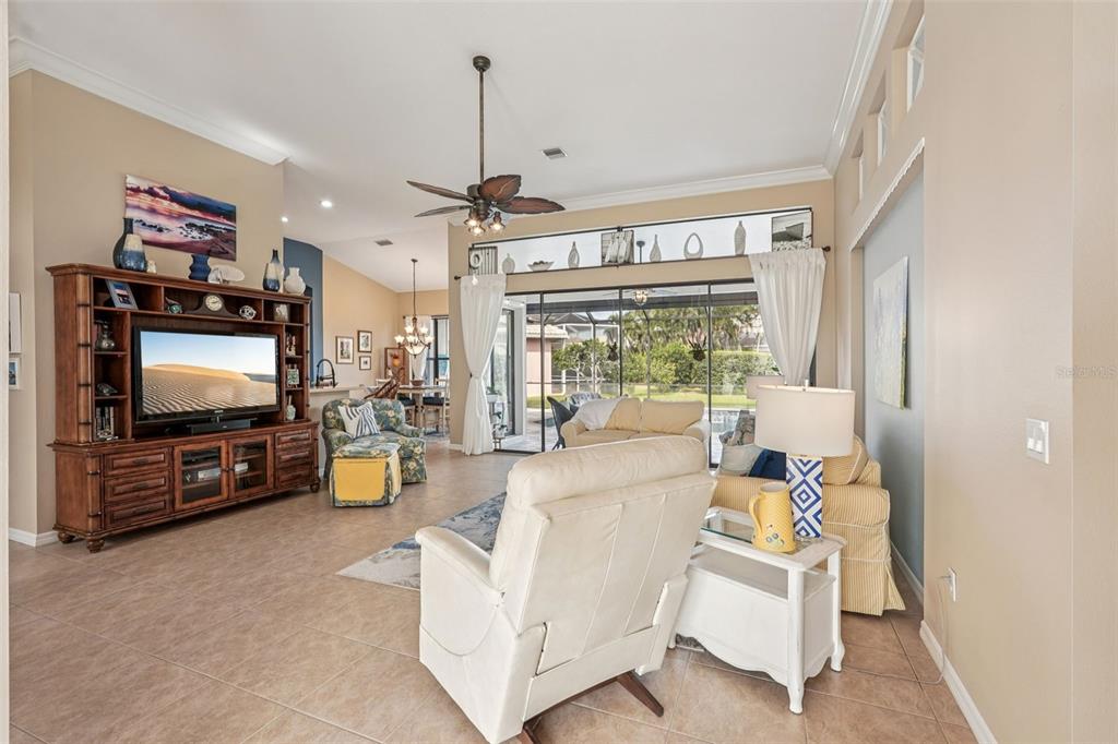 626 May Apple Way Venice, FL 34293 - Photo 17 of 60 a living room with furniture and a flat screen tv