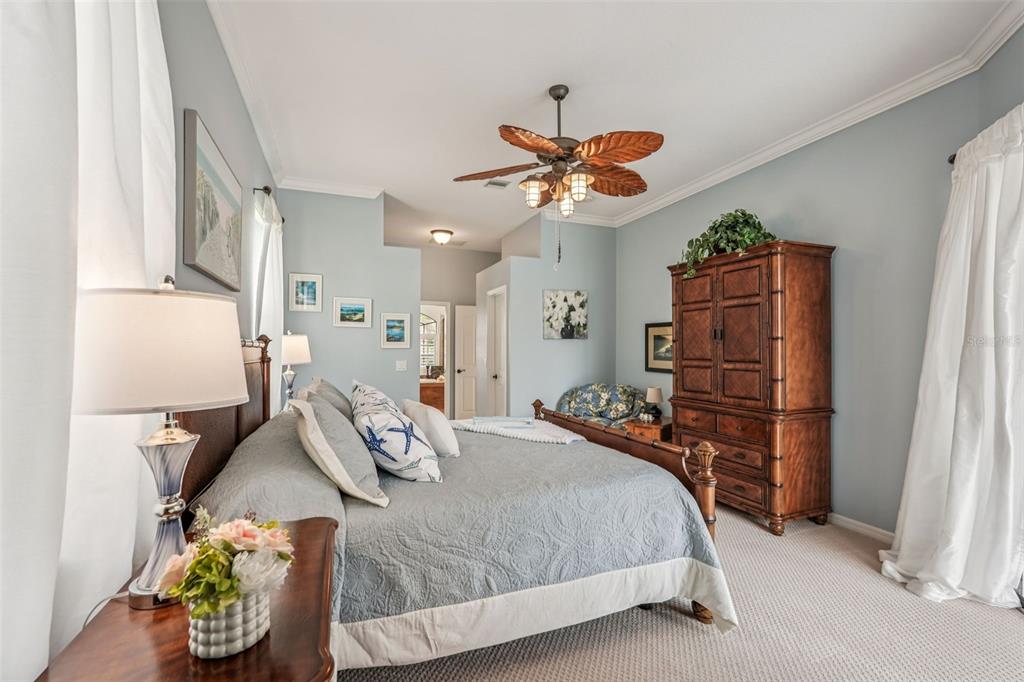 626 May Apple Way Venice, FL 34293 - Photo 20 of 60 a bedroom with a bed and ceiling fan