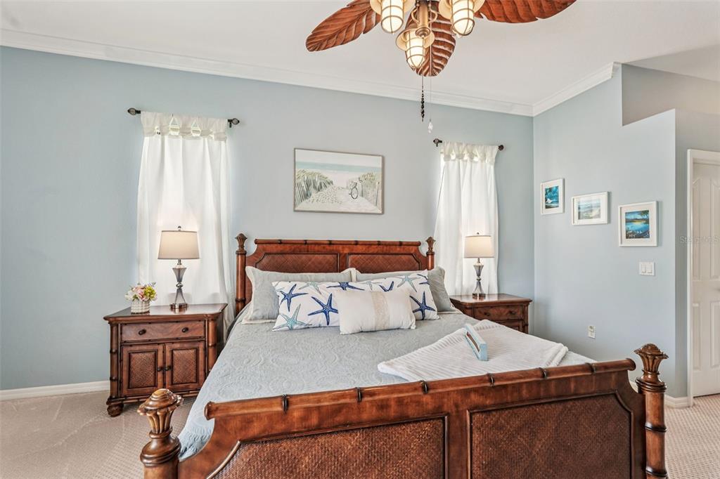 626 May Apple Way Venice, FL 34293 - Photo 21 of 60 a bedroom with a bed and a chandelier