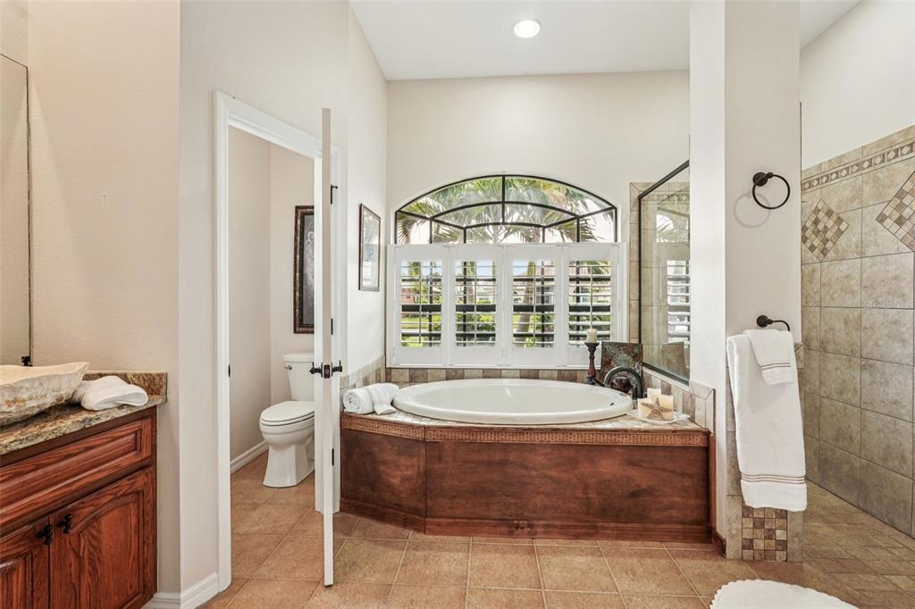 626 May Apple Way Venice, FL 34293 - Photo 23 of 60 a spacious bathroom with a tub a window and a shower