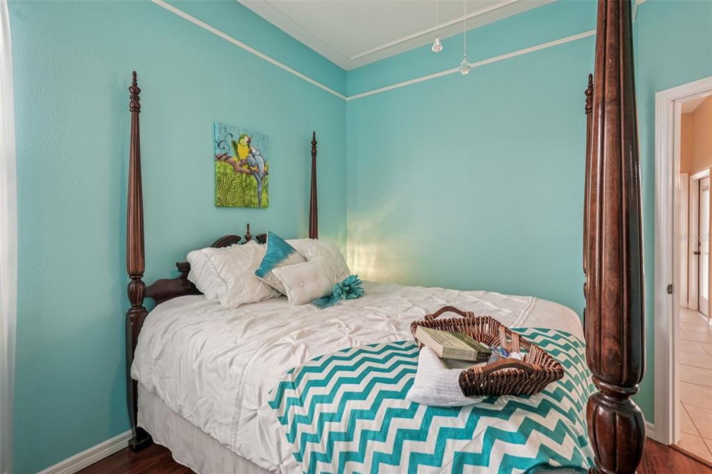 626 May Apple Way Venice, FL 34293 - Photo 28 of 60 a bedroom with a bed and a painting on the wall