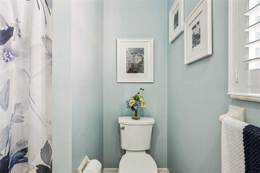 626 May Apple Way Venice, FL 34293 - Photo 31 of 60 a bathroom with a toilet a sink and a shower curtain