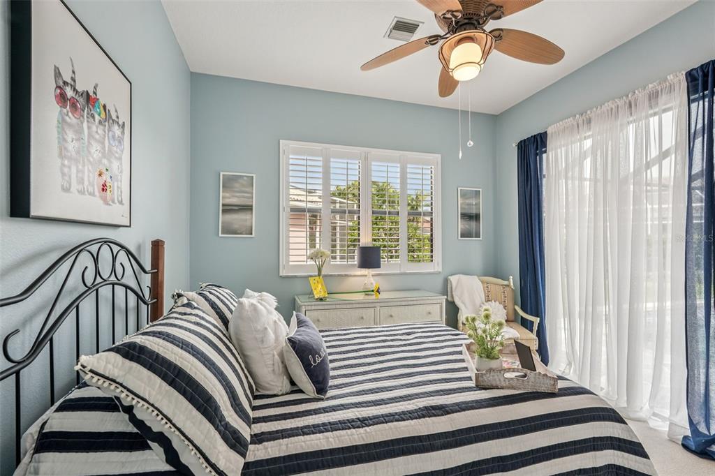 626 May Apple Way Venice, FL 34293 - Photo 33 of 60 a bed sitting in a bedroom next to a window