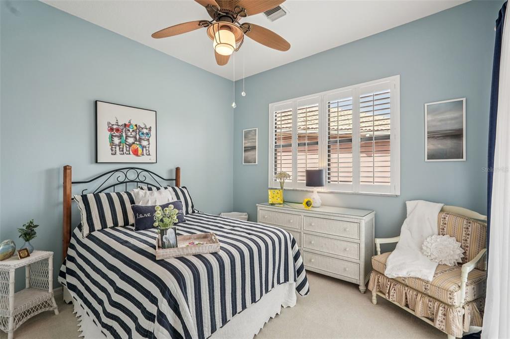 626 May Apple Way Venice, FL 34293 - Photo 7 of 60 a bedroom with a bed and a chandelier