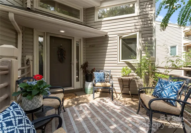 a balcony with furniture and flowers