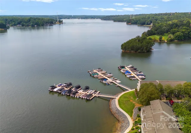an aerial view of a house with pool lake view and mountain view