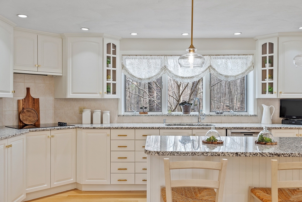 24 Greybirch Road Andover, MA 01810 - Photo 12 of 42 a kitchen with granite countertop a stove a sink and cabinets