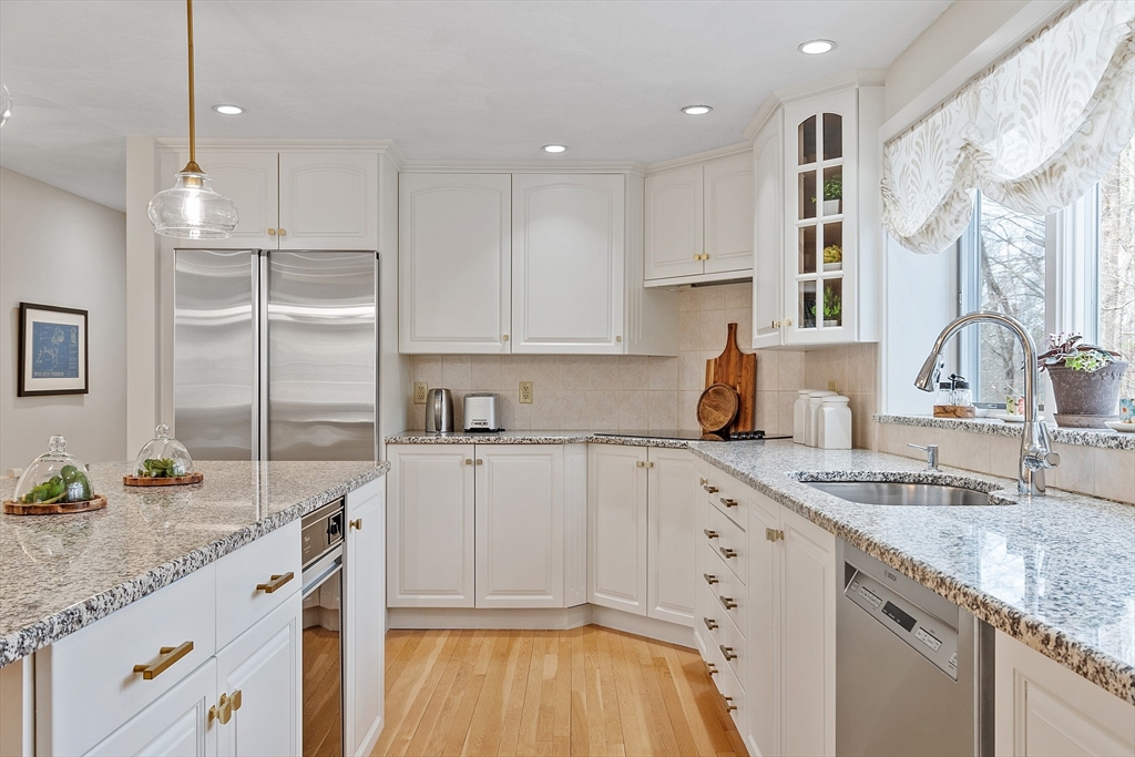 24 Greybirch Road Andover, MA 01810 - Photo 14 of 42 a kitchen with granite countertop a sink stainless steel appliances and white cabinets
