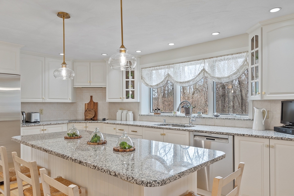 24 Greybirch Road Andover, MA 01810 - Photo 15 of 42 a kitchen with stainless steel appliances granite countertop a sink a stove and a wooden floor