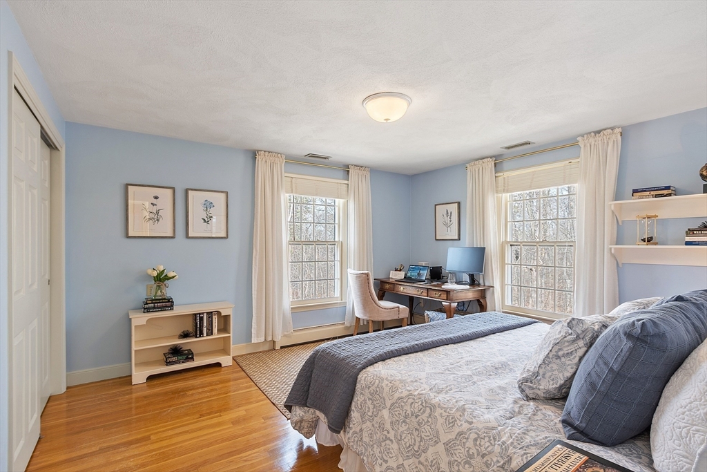 24 Greybirch Road Andover, MA 01810 - Photo 27 of 42 a bedroom with a bed and wooden floor