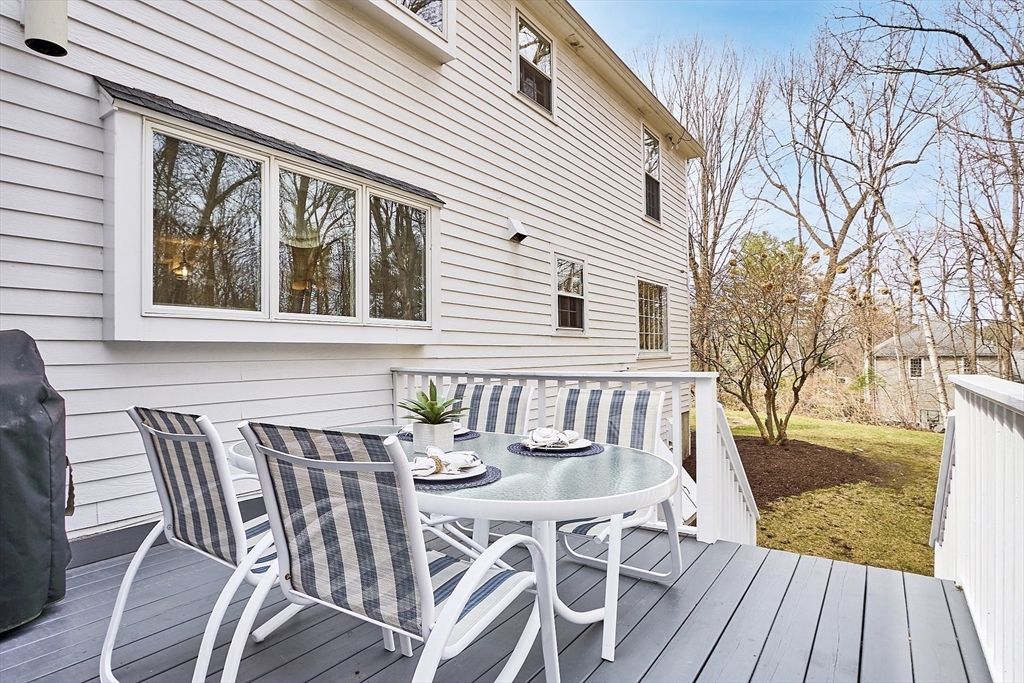24 Greybirch Road Andover, MA 01810 - Photo 33 of 42 a view of a patio with table and chairs and wooden floor