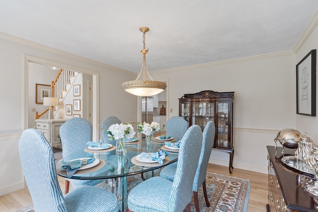 24 Greybirch Road Andover, MA 01810 - Photo 9 of 42 a dining room with furniture a chandelier and wooden floor