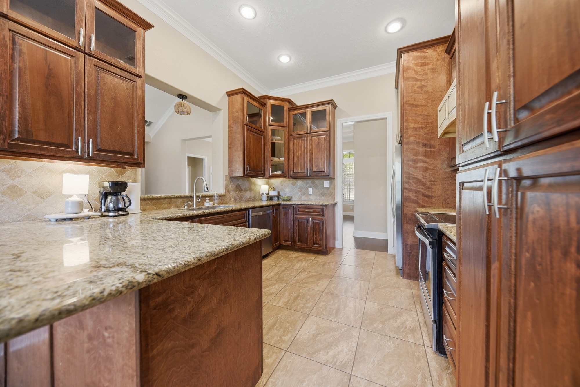 2245 Strangmeier Road Brenham, TX 77833 - Photo 20 of 40 Custom kitchen with tons of storage space and sightlines to the living room.