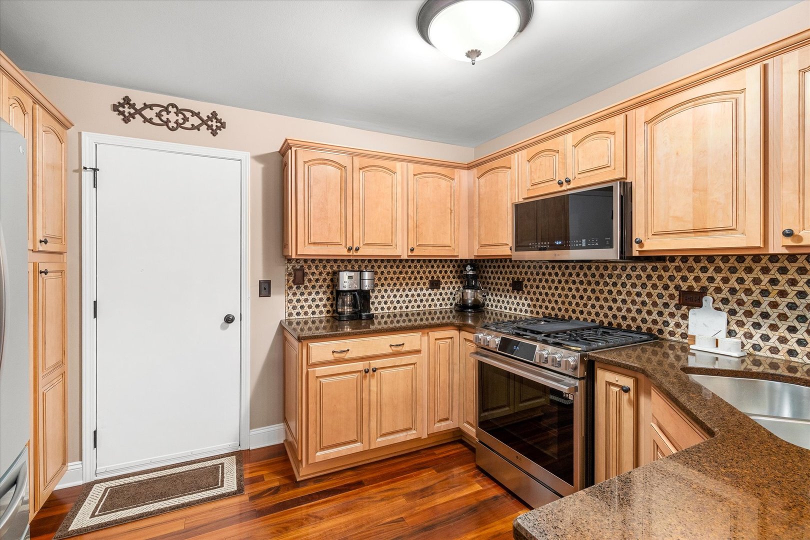 3819 Capri Court Naperville, IL 60564 - Photo 9 of 37 a kitchen with a stove a sink and a microwave