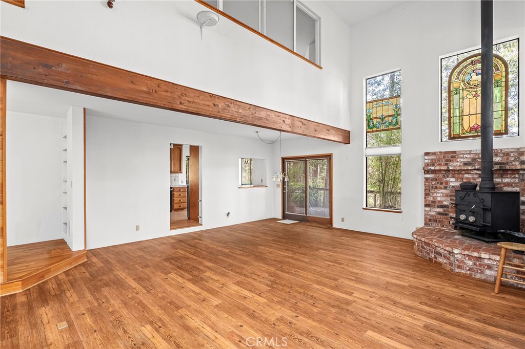 14243 Wycliff Way Magalia, CA 95954 - Photo 13 of 65 a view of an empty room with wooden floor and a window