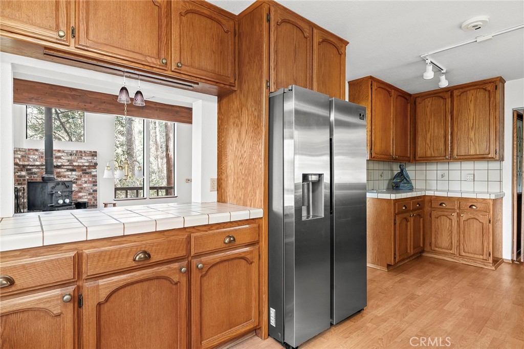 14243 Wycliff Way Magalia, CA 95954 - Photo 15 of 65 a kitchen with stainless steel appliances granite countertop a refrigerator and a sink