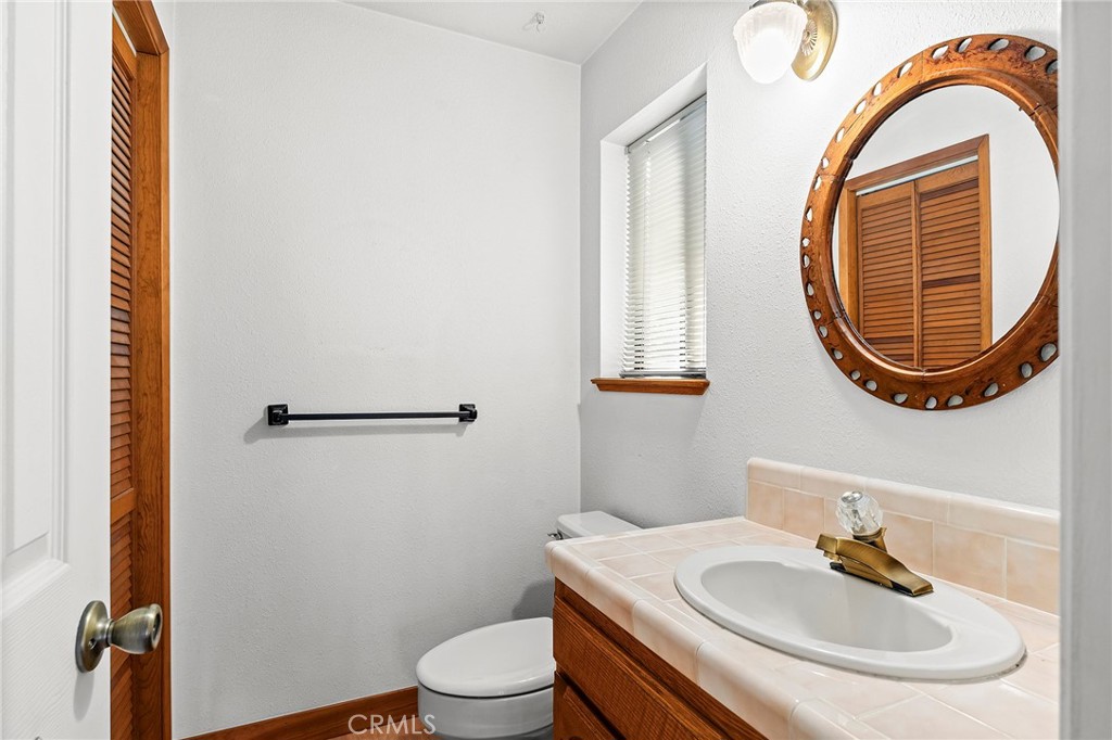 14243 Wycliff Way Magalia, CA 95954 - Photo 20 of 65 a bathroom with a sink a toilet and a mirror