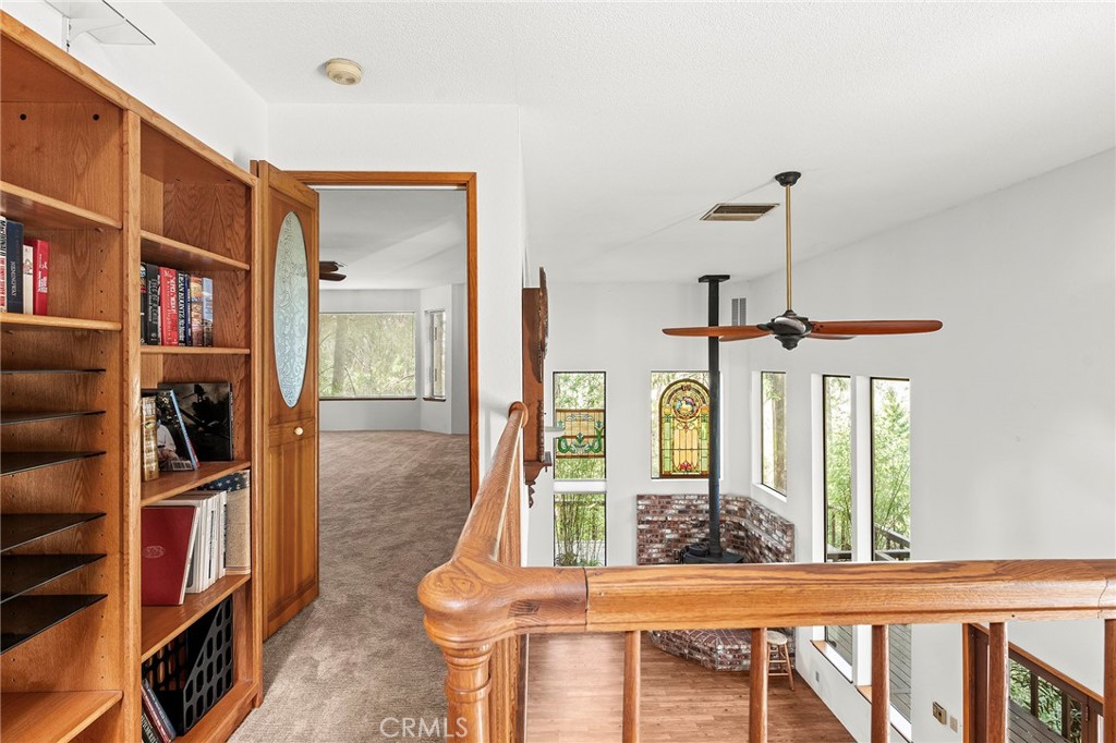 14243 Wycliff Way Magalia, CA 95954 - Photo 22 of 65 a living room with furniture a bookshelf and a window