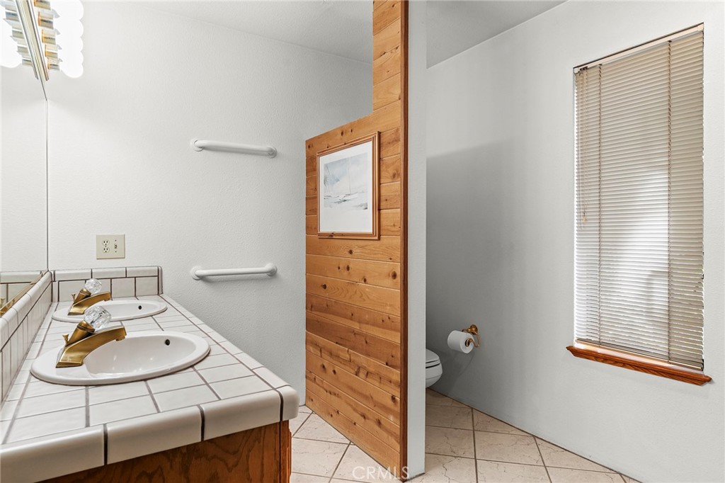 14243 Wycliff Way Magalia, CA 95954 - Photo 26 of 65 a bathroom with a sink and a mirror