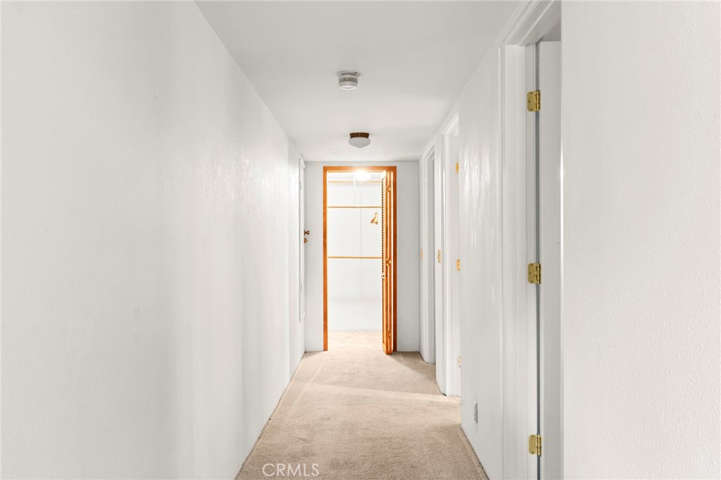 14243 Wycliff Way Magalia, CA 95954 - Photo 30 of 65 a view of a hallway with wooden floor and a bathroom