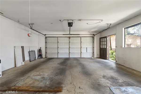 a kitchen with stainless steel appliances a sink a stove a refrigerator and a dining table