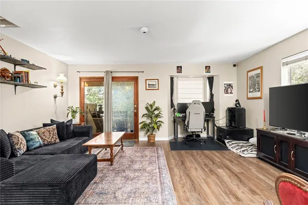 a bedroom with a bed and a flat tv screen on the dresser