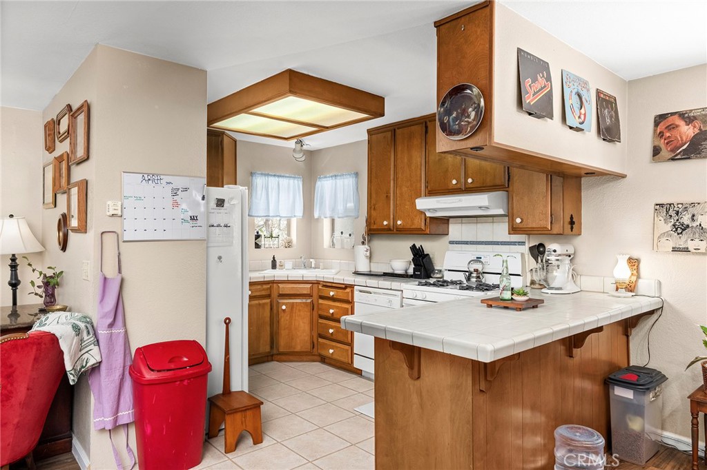14243 Wycliff Way Magalia, CA 95954 - Photo 49 of 65 a kitchen with stainless steel appliances a sink a stove a refrigerator and a dining table
