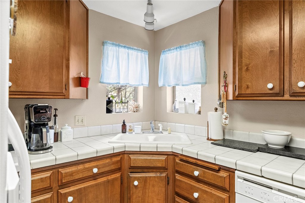 14243 Wycliff Way Magalia, CA 95954 - Photo 50 of 65 a kitchen with stainless steel appliances granite countertop a sink and cabinets