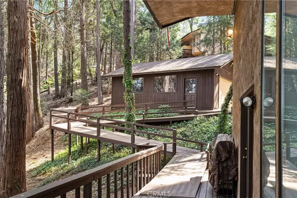 a front view of house with yard and trees around