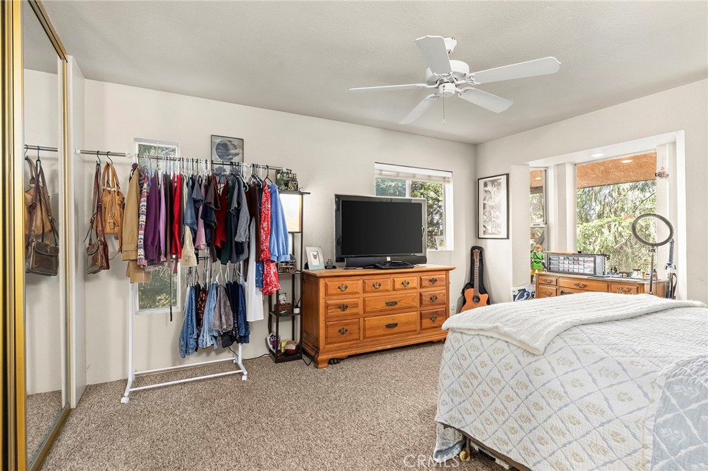 14243 Wycliff Way Magalia, CA 95954 - Photo 53 of 65 a bedroom with a bed and a flat tv screen on the dresser